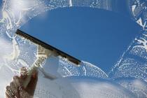 bigstock Window cleaner using a squeege 30983438
